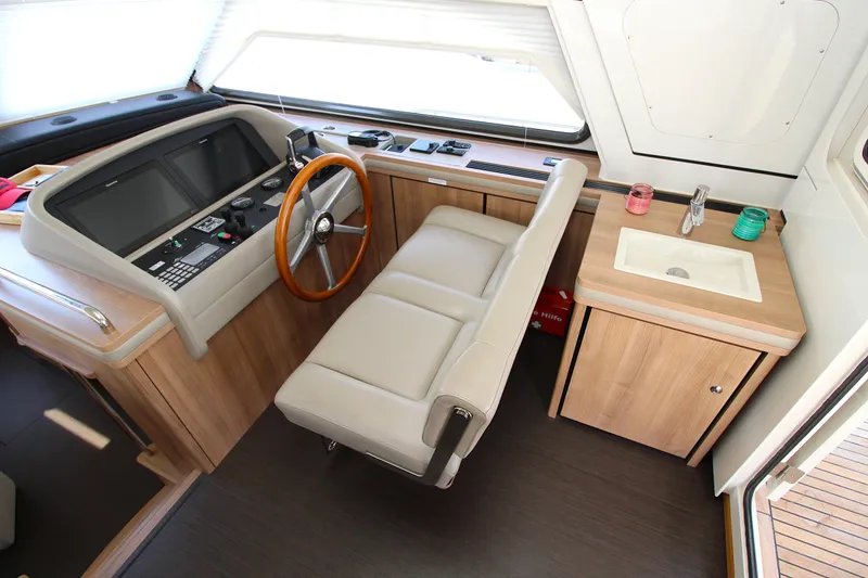  Yacht Photos Pics 2024 Linssen 55 SL AC Variotop helm station with modern controls and wooden accents.