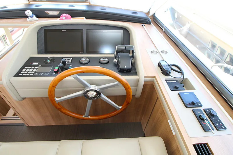  Yacht Photos Pics 2024 Linssen 55 SL AC Variotop yacht helm with wooden steering wheel and modern controls.