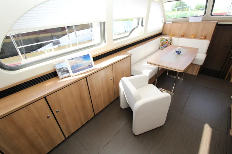  Yacht Photos Pics Luxurious interior of 2024 Linssen 55 SL AC Variotop yacht with elegant seating and dining area.