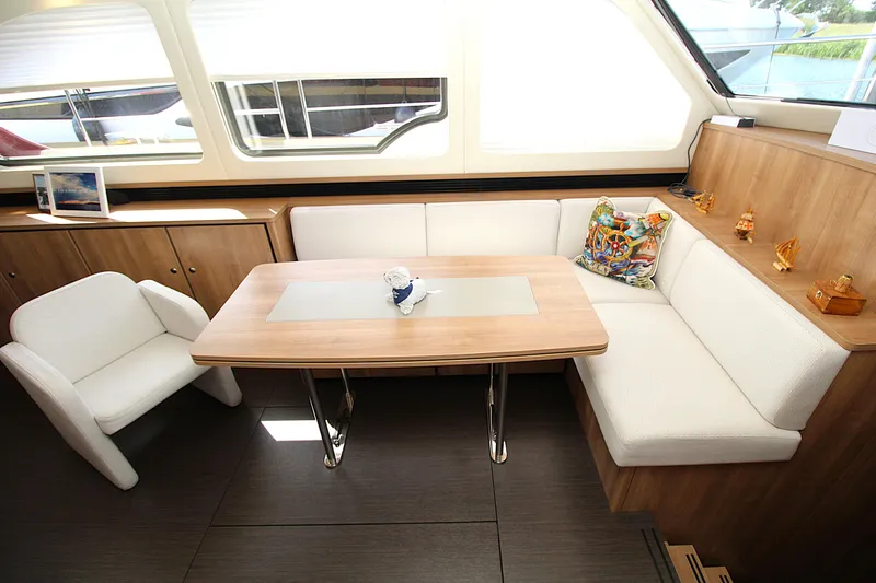  Yacht Photos Pics Luxurious interior of 2024 Linssen 55 SL AC Variotop yacht with elegant seating and table.