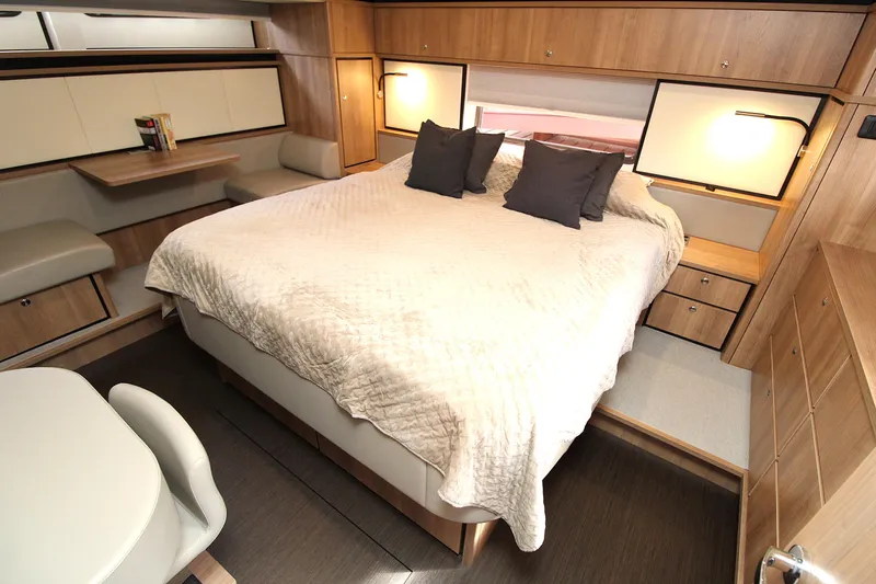  Yacht Photos Pics Luxurious bedroom interior of 2024 Linssen 55 SL AC Variotop yacht, featuring elegant wood finishes.