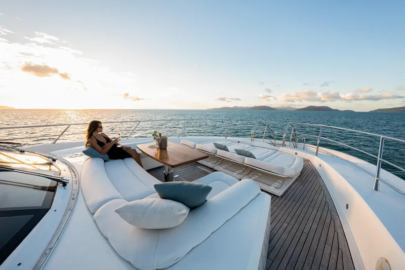 2015 Sunseeker 115' Sport Yacht Yacht Photos Pics Luxurious 2015 Sunseeker 115 Sport Yacht deck with woman relaxing at sunset.