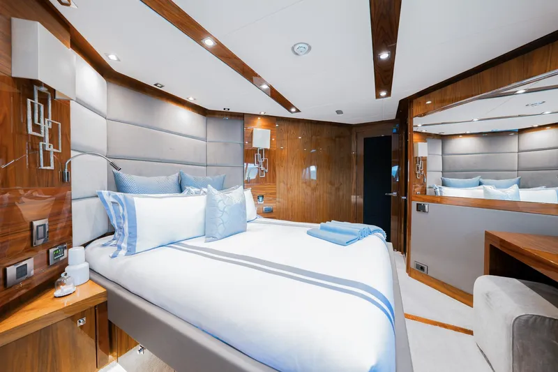 2015 Sunseeker 115' Sport Yacht Yacht Photos Pics Luxurious bedroom interior of 2015 Sunseeker 115 Sport Yacht with elegant wood paneling and plush bedding.