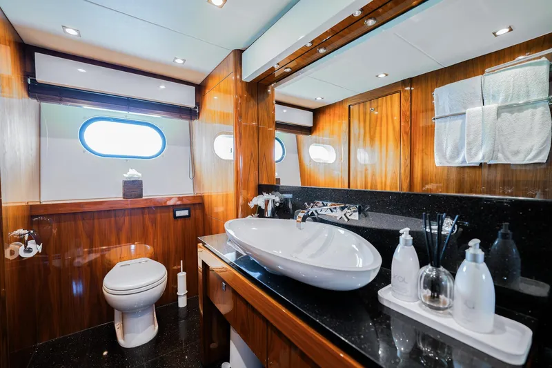 2015 Sunseeker 115' Sport Yacht Yacht Photos Pics Luxurious bathroom on 2015 Sunseeker 115 Sport Yacht with elegant wood paneling and modern fixtures.