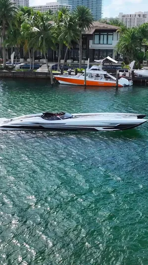  Yacht Photos Pics Luxury MTI 52RP speedboat cruising on turquoise water near waterfront homes, 2018 model.
