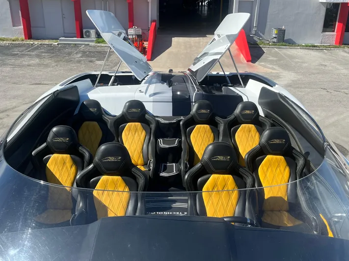  Yacht Photos Pics 2018 MTI 52RP speedboat with yellow and black seating, open hatches, docked at marina.