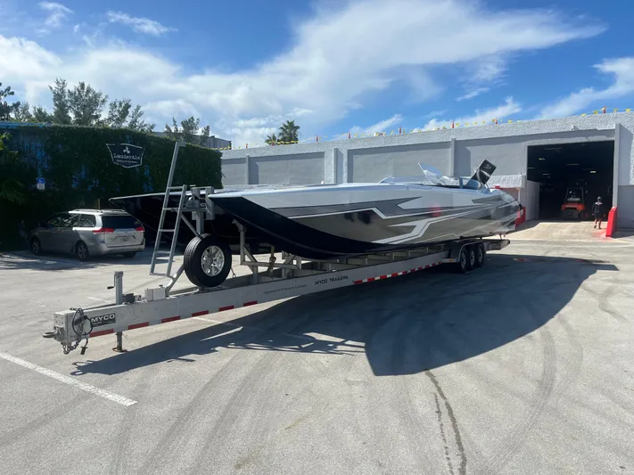  Yacht Photos Pics 2018 MTI 52RP speedboat on trailer in sunny parking lot.