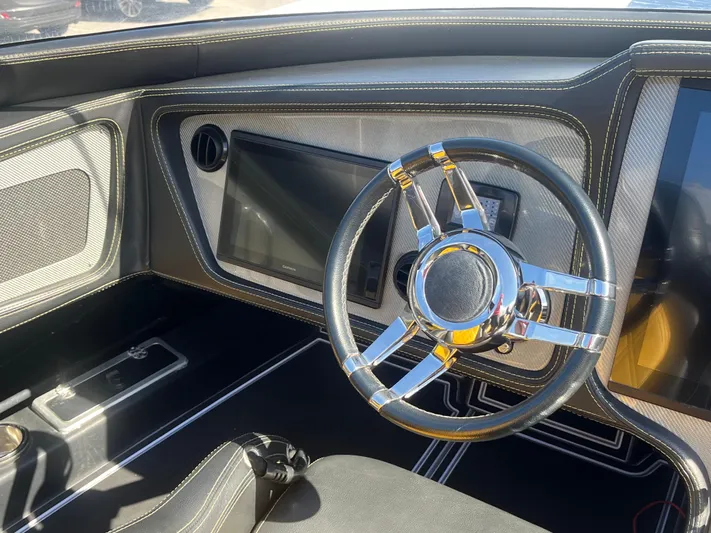  Yacht Photos Pics Sleek 2018 MTI 52RP boat interior with modern steering wheel and dashboard.