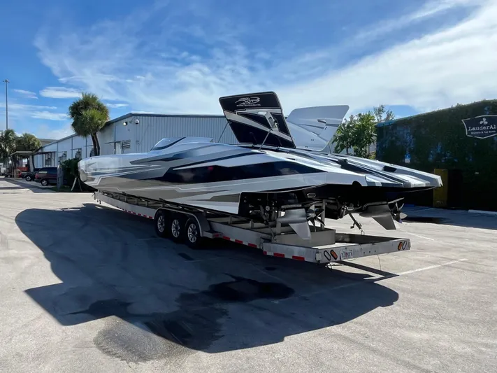  Yacht Photos Pics Sleek 2018 MTI 52RP powerboat on trailer under clear blue sky.