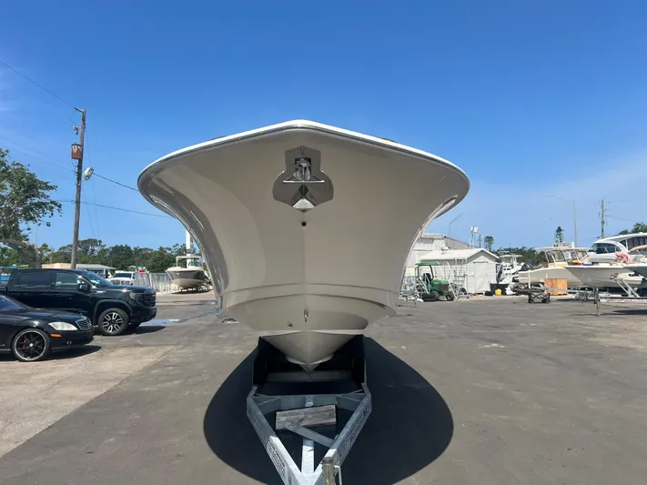  Yacht Photos Pics 2025 Scout 357 LXF boat on trailer, viewed from the front, in a sunny outdoor setting.