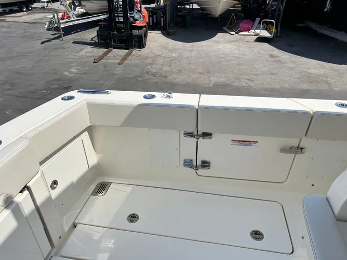  Yacht Photos Pics 2025 Scout 357 LXF boat deck with storage compartments and seating area.