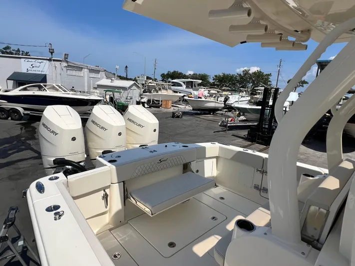  Yacht Photos Pics 2025 Scout 357 LXF boat with Mercury engines at a marina.