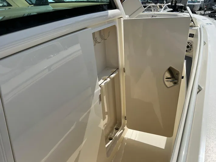  Yacht Photos Pics Open storage compartment on 2025 Scout 357 LXF boat, showcasing interior features.
