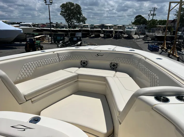 Yacht Photos Pics 2025 Scout 357 LXF boat interior with luxurious seating and cup holders, docked at a marina.