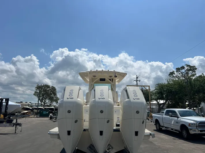  Yacht Photos Pics 2025 Scout 357 LXF boat with triple V12 engines under a clear blue sky.