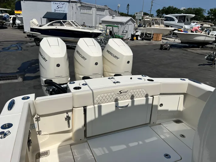  Yacht Photos Pics 2025 Scout 357 LXF boat with triple Mercury engines in a marina setting.