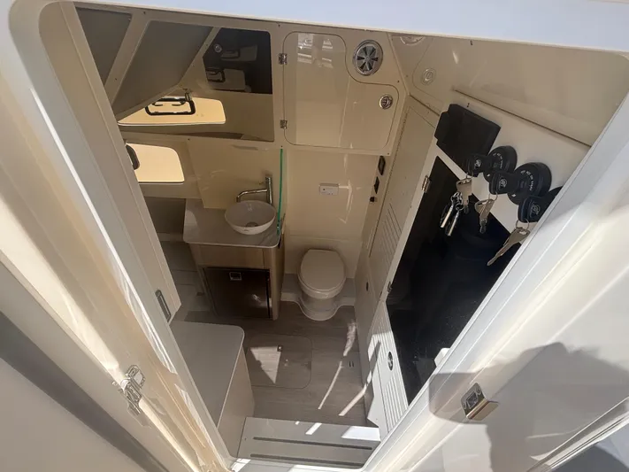  Yacht Photos Pics Interior of 2025 Scout 357 LXF boat featuring a compact bathroom with sink and toilet.