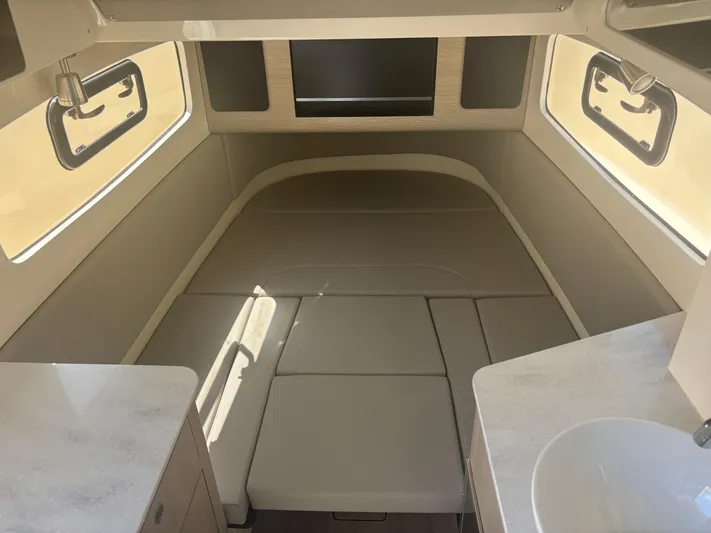  Yacht Photos Pics 2025 Scout 357 LXF cabin interior with beige seating and modern design.