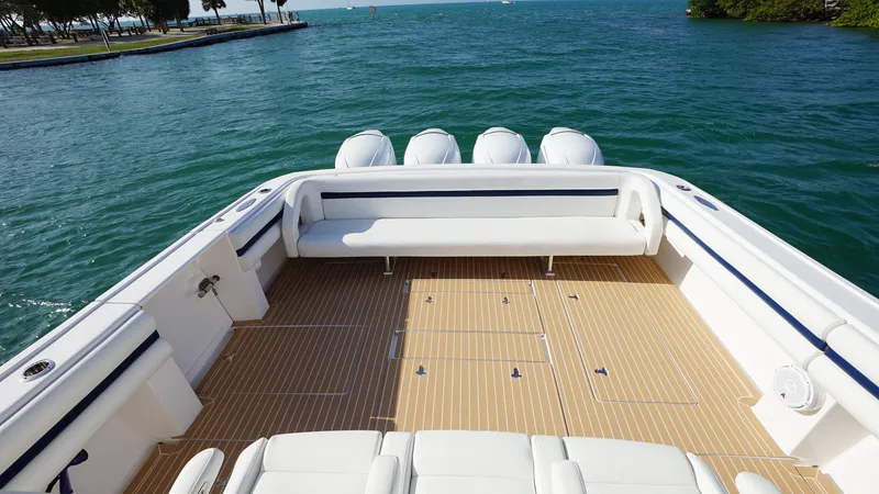 Audacious Yacht Photos Pics 2016 Intrepid 475 Panacea boat with spacious deck and seating, docked on calm waters.