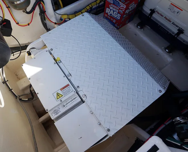 Audacious Yacht Photos Pics Engine compartment of a 2016 Intrepid 475 Panacea boat with metal cover.