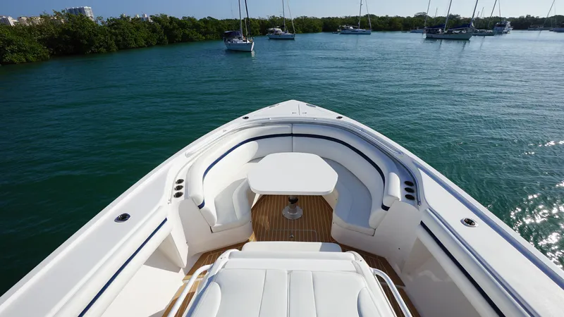 Audacious Yacht Photos Pics 2016 Intrepid 475 Panacea boat bow with seating and table on calm water.