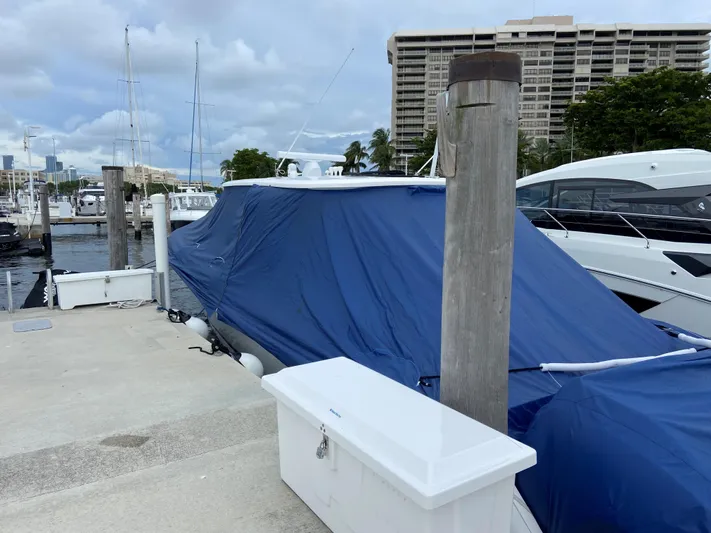 Audacious Yacht Photos Pics 2016 Intrepid 475 Panacea boat covered with blue tarp at marina dock.