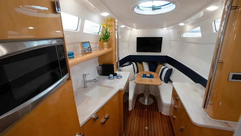 Audacious Yacht Photos Pics Interior of 2016 Intrepid 475 Panacea yacht with modern amenities and cozy seating area.
