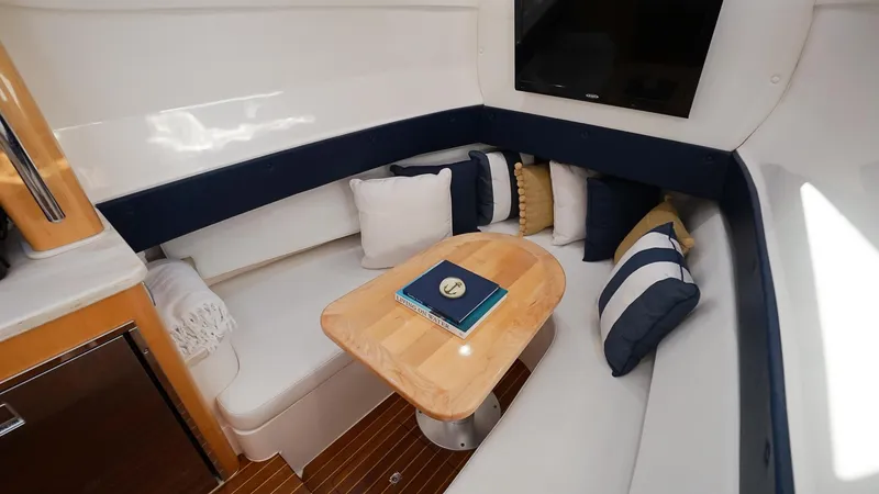 Audacious Yacht Photos Pics 2016 Intrepid 475 Panacea cabin with cozy seating and wooden table.