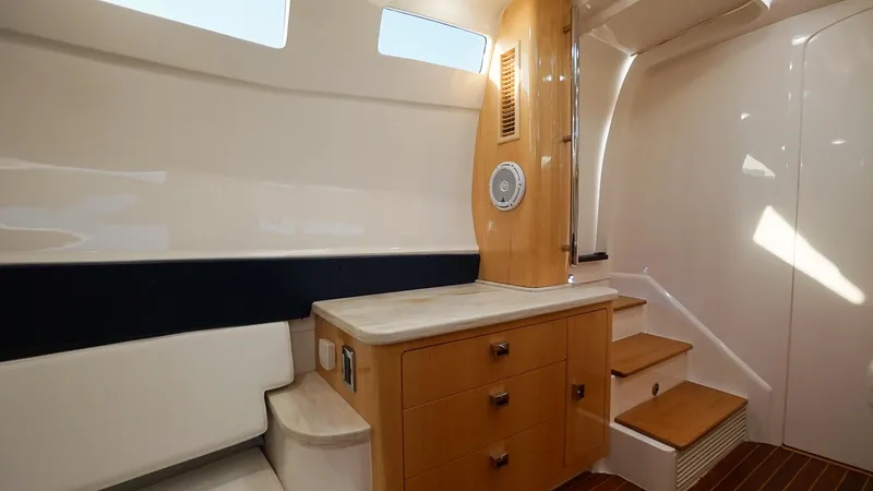 Audacious Yacht Photos Pics Interior of 2016 Intrepid 475 Panacea yacht with wooden cabinetry and seating.