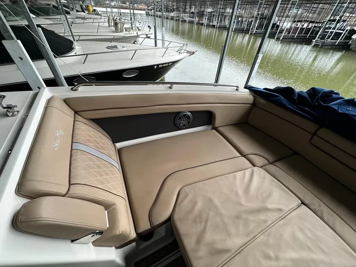  Yacht Photos Pics 2016 Sea Ray SDX 290 boat interior with tan leather seating at a marina.