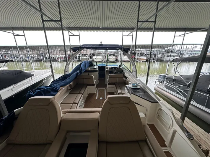  Yacht Photos Pics 2016 Sea Ray SDX 290 boat docked, featuring spacious seating and covered marina view.