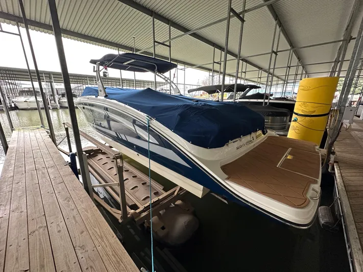  Yacht Photos Pics 2016 Sea Ray SDX 290 boat docked under a covered marina.