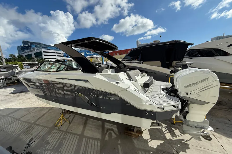  Yacht Photos Pics 2019 Cruisers Yachts 338 Outboard with Mercury engine, docked under a sunny sky.