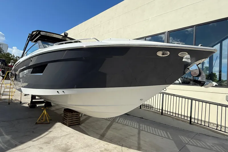  Yacht Photos Pics 2019 Cruisers Yachts 338 Outboard displayed outdoors, sleek design, black and white hull.