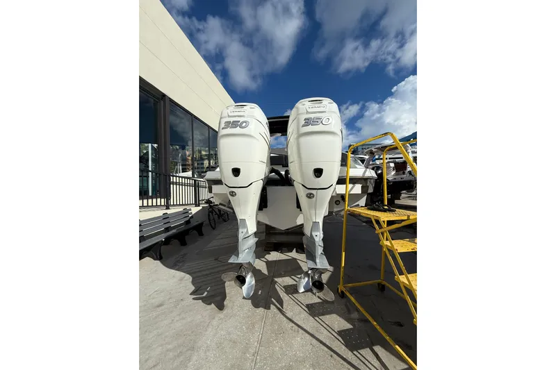  Yacht Photos Pics 2019 Cruisers Yachts 338 Outboard with twin 350 engines, docked under a clear sky.
