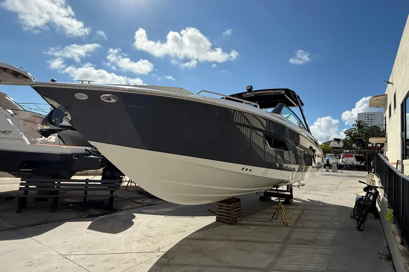  Yacht Photos Pics 2019 Cruisers Yachts 338 Outboard on display under a clear blue sky.