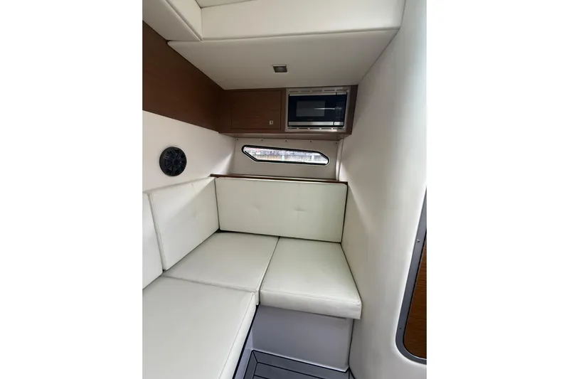  Yacht Photos Pics 2019 Cruisers Yachts 338 Outboard cabin interior with white seating and microwave.