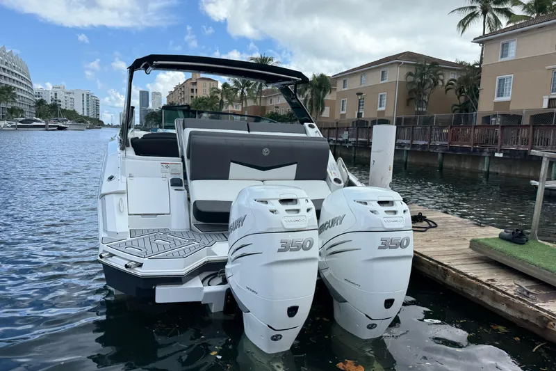  Yacht Photos Pics 2019 Cruisers Yachts 338 Outboard with twin Mercury 350 engines docked by waterfront homes.