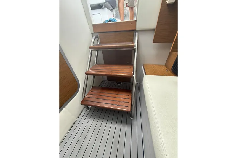  Yacht Photos Pics Wooden steps inside 2019 Cruisers Yachts 338 Outboard, featuring sleek interior design.