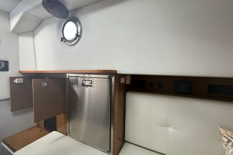  Yacht Photos Pics Interior of 2019 Cruisers Yachts 338 Outboard, featuring a compact cabin with porthole.