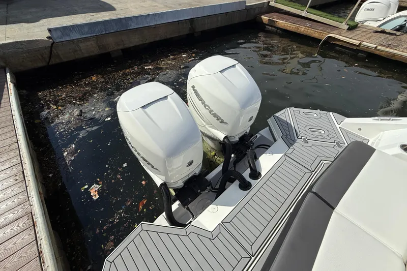  Yacht Photos Pics 2019 Cruisers Yachts 338 Outboard with twin Mercury engines docked in a marina.