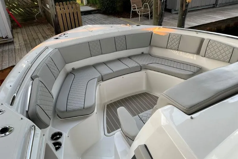  Yacht Photos Pics 2023 Pursuit S 358 Sport boat with luxurious gray seating and spacious deck area.