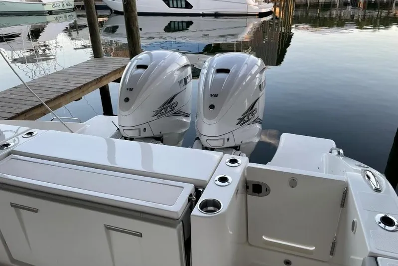  Yacht Photos Pics 2023 Pursuit S 358 Sport boat with twin outboard engines docked at marina.