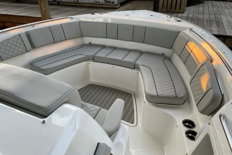  Yacht Photos Pics Luxurious seating area on 2023 Pursuit S 358 Sport boat, featuring elegant gray upholstery.