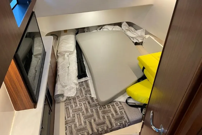  Yacht Photos Pics Interior cabin of 2023 Pursuit S 358 Sport boat with cushions and storage.
