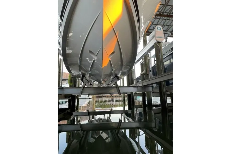  Yacht Photos Pics 2023 Pursuit S 358 Sport boat hull in marina, reflecting on water.