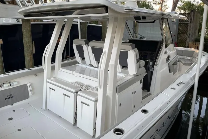  Yacht Photos Pics 2023 Pursuit S 358 Sport boat interior with seating and storage compartments.