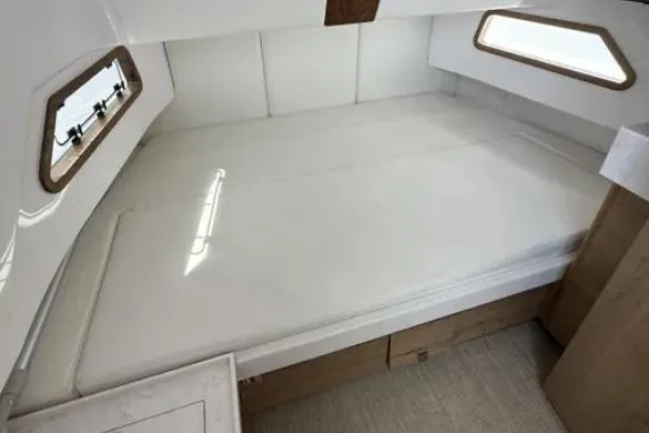  Yacht Photos Pics 2024 Bertram 39 CC cabin interior with spacious bed and modern design.