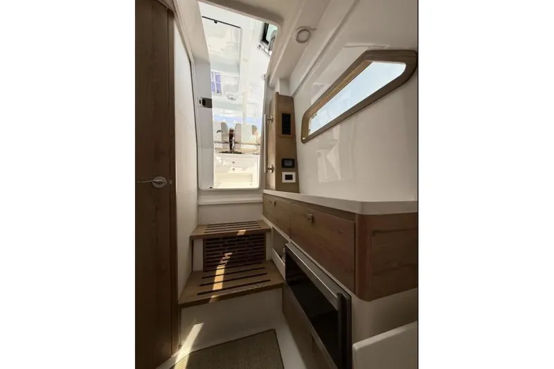  Yacht Photos Pics 2024 Bertram 39 CC interior cabin with modern wood accents and natural light.