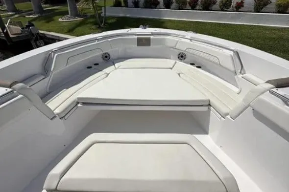  Yacht Photos Pics 2024 Bertram 39 CC boat interior with white cushioned seating and sleek design.